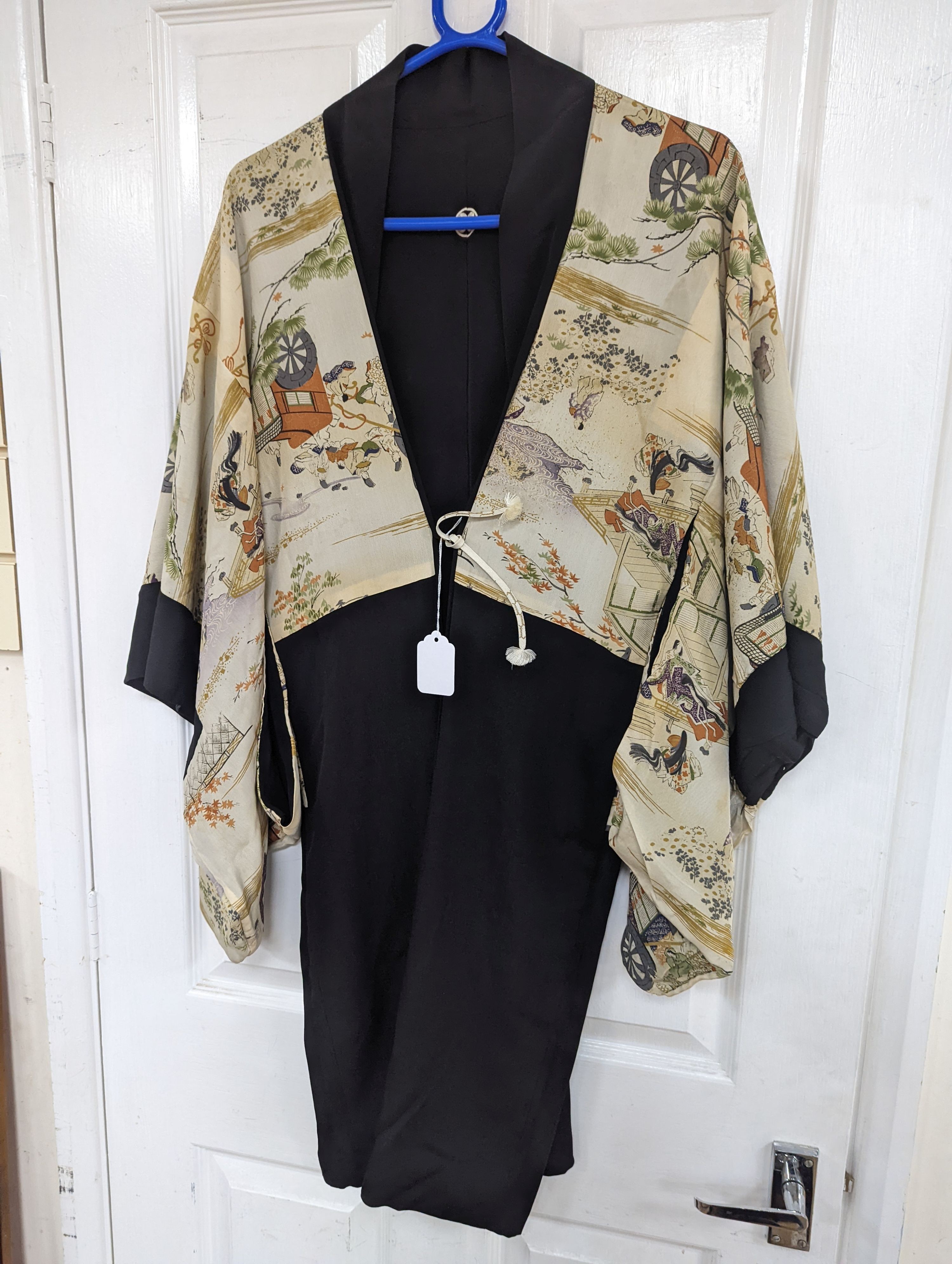 A 1920's Chinese dragon embroidered waistcoat, a cream silk drawn thread dress and a silk crepe black and patterned reversible kimono (3 items).